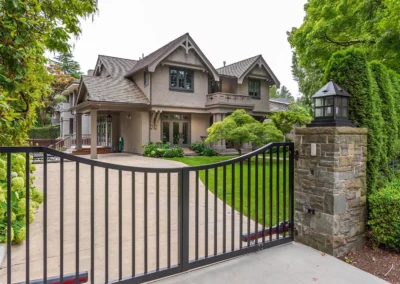 swing style driveway gate framing entry of holly springs home